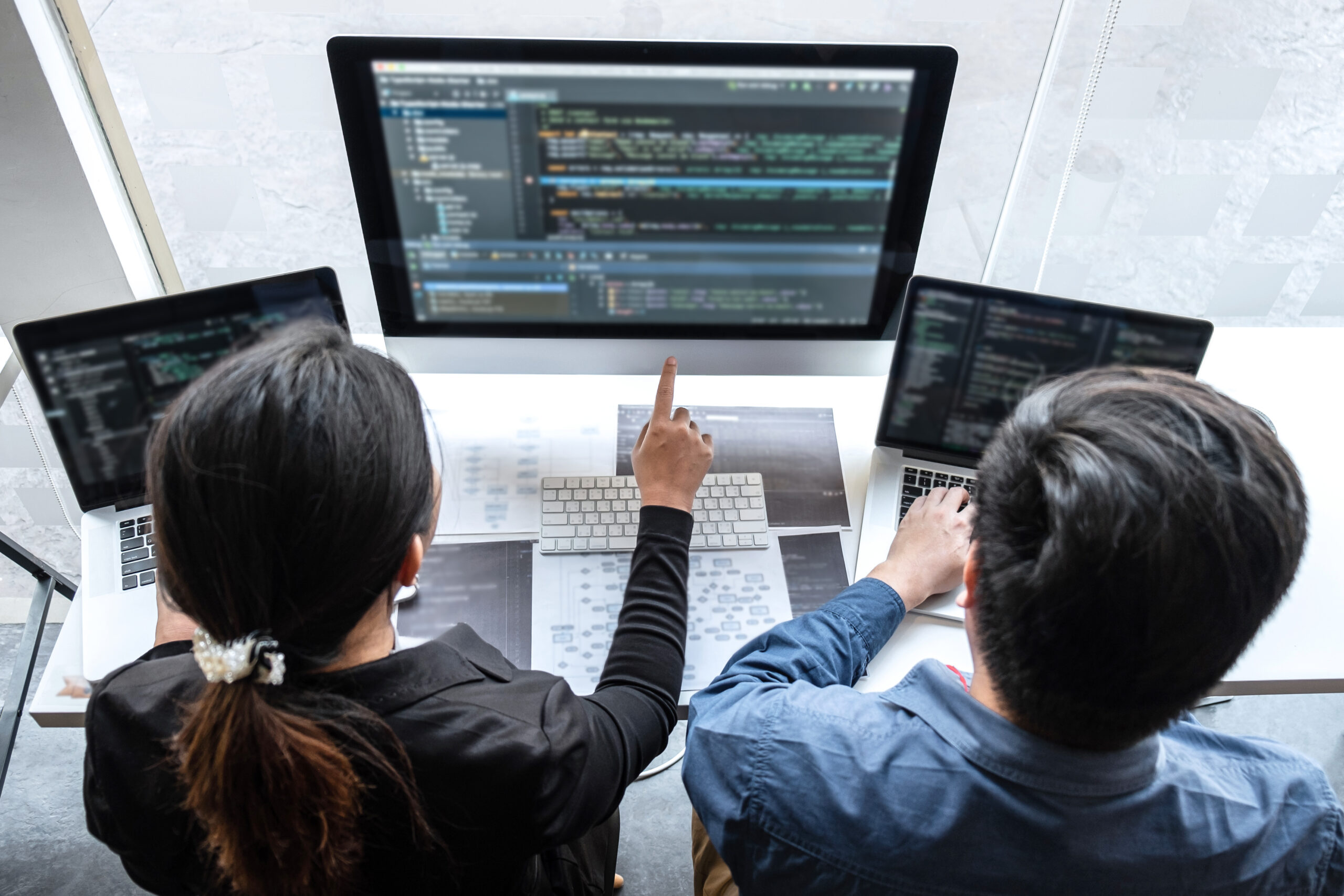 Professional Team of programmer working on project in software development computer in IT company office, Writing codes and data code website and coding database technologies on new Application
