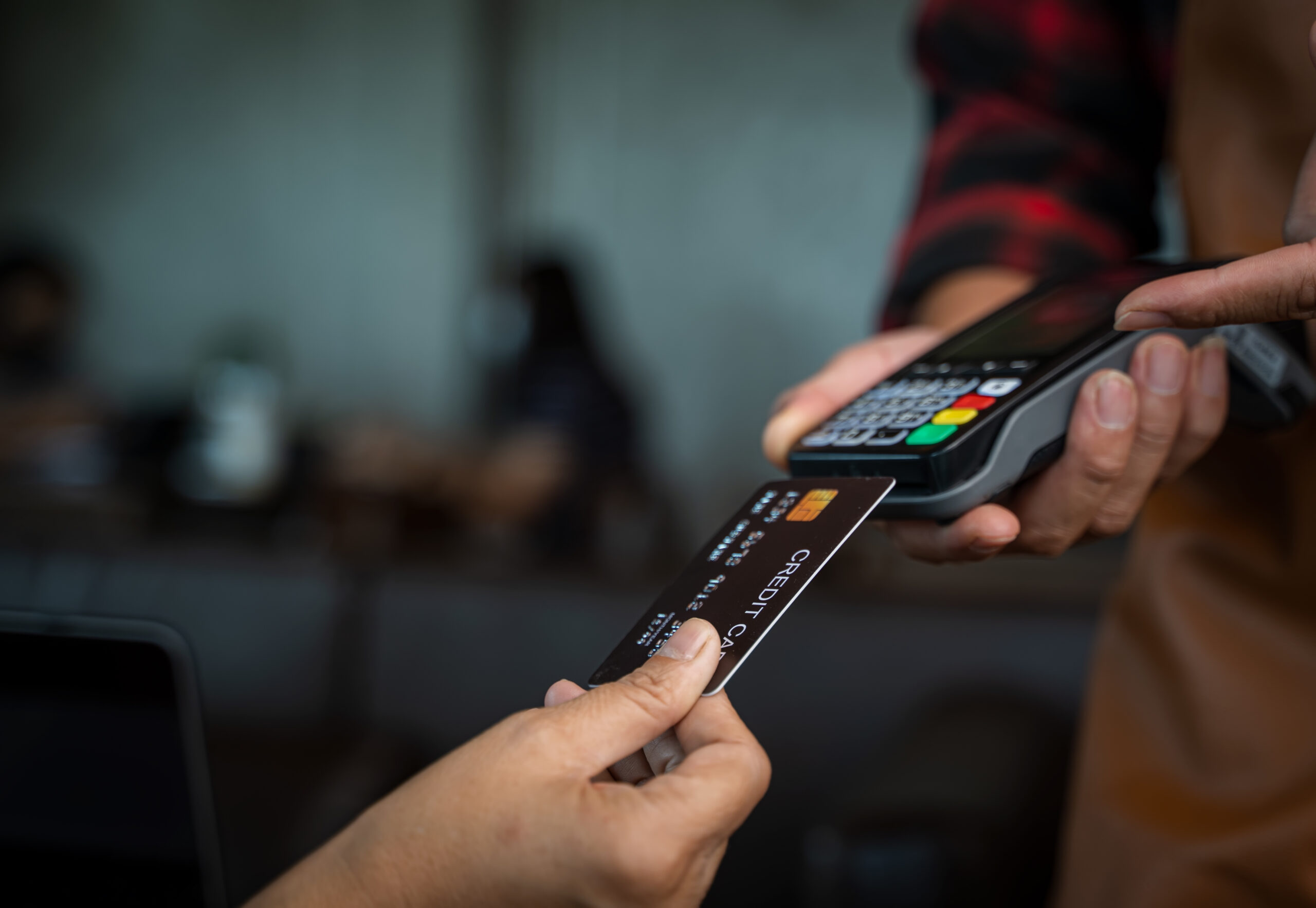 Customer paying through payment terminal in hands of waitress,Cr